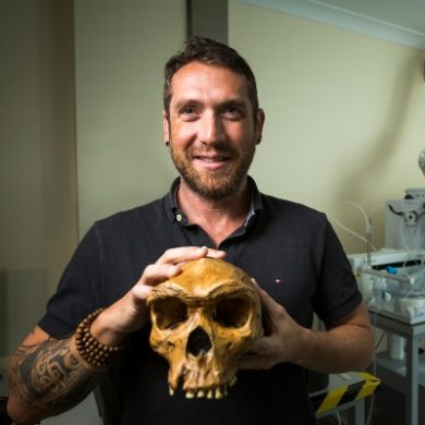 Renaud Joannes-Boyau holding the cast of the Kabwe skull (South Africa) in the Geoarchaeology and Archaeometry Research Group (GARG) facility in G block Lismore campus.
